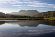 A Lake near a Mountain under a Blue Sky