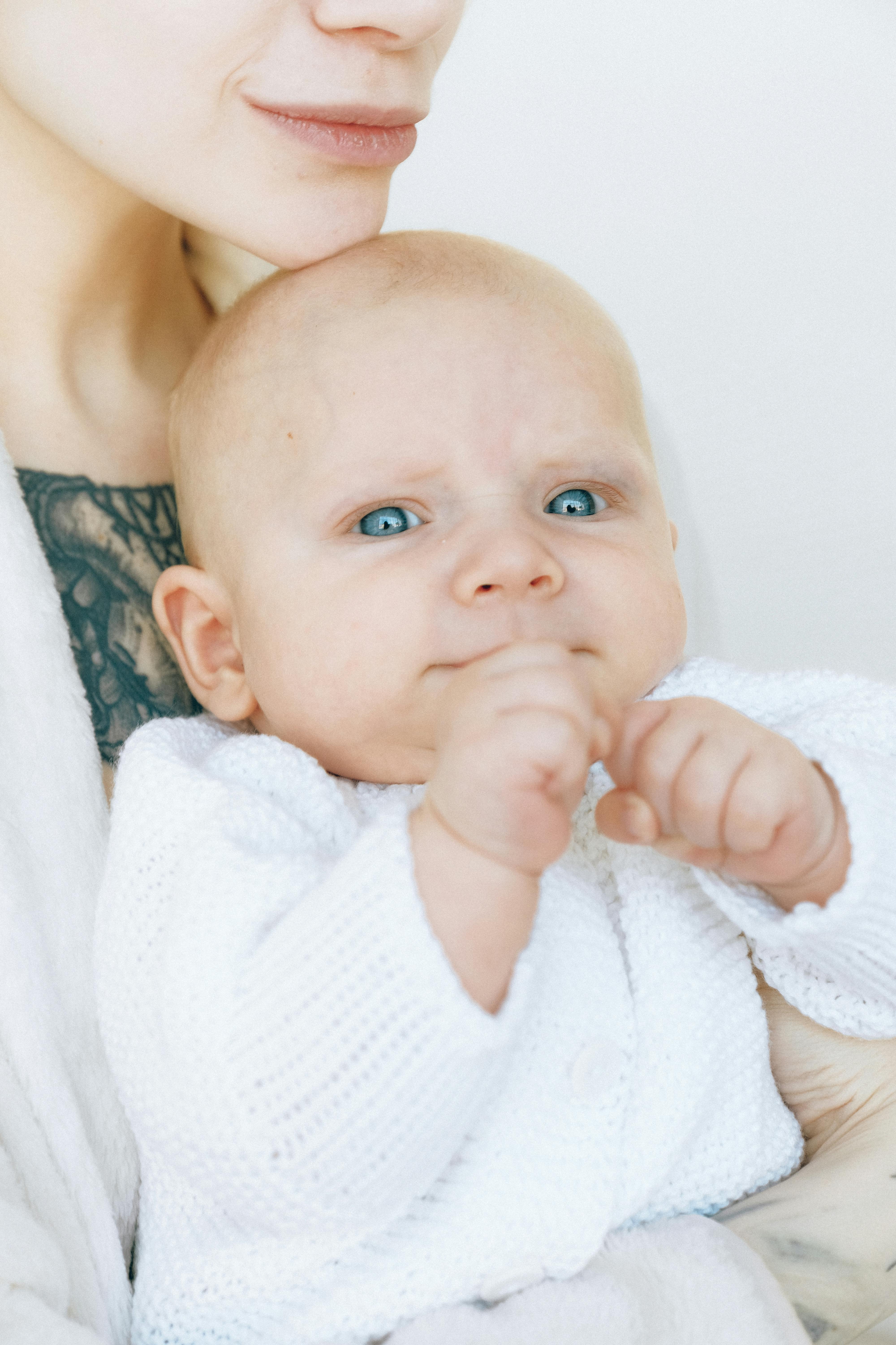 baby in white knit shirt