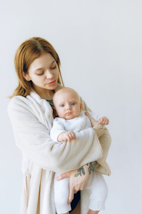 Free Mother Carrying Her Cute Baby Stock Photo