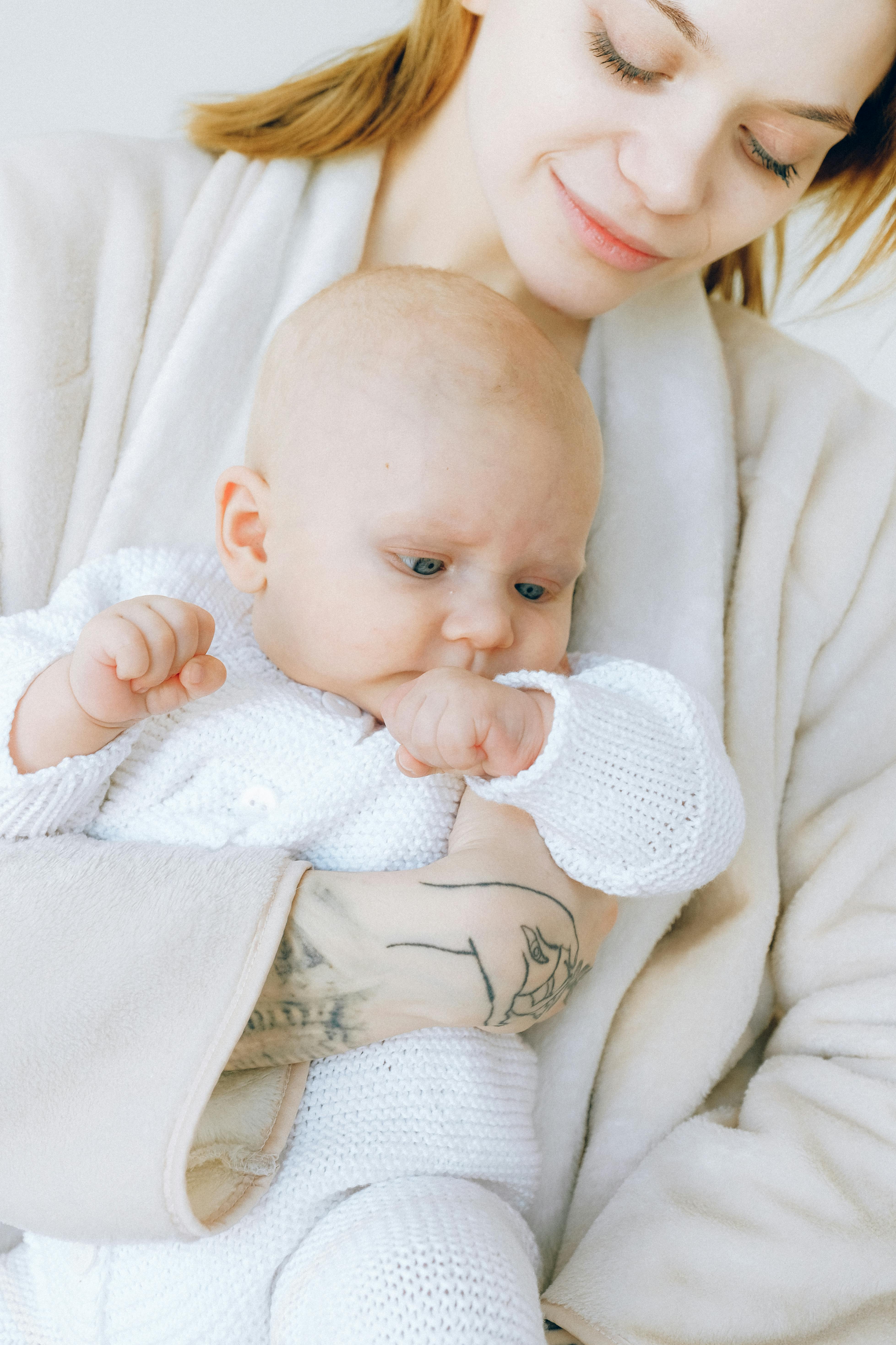 baby in white long sleeve shirt