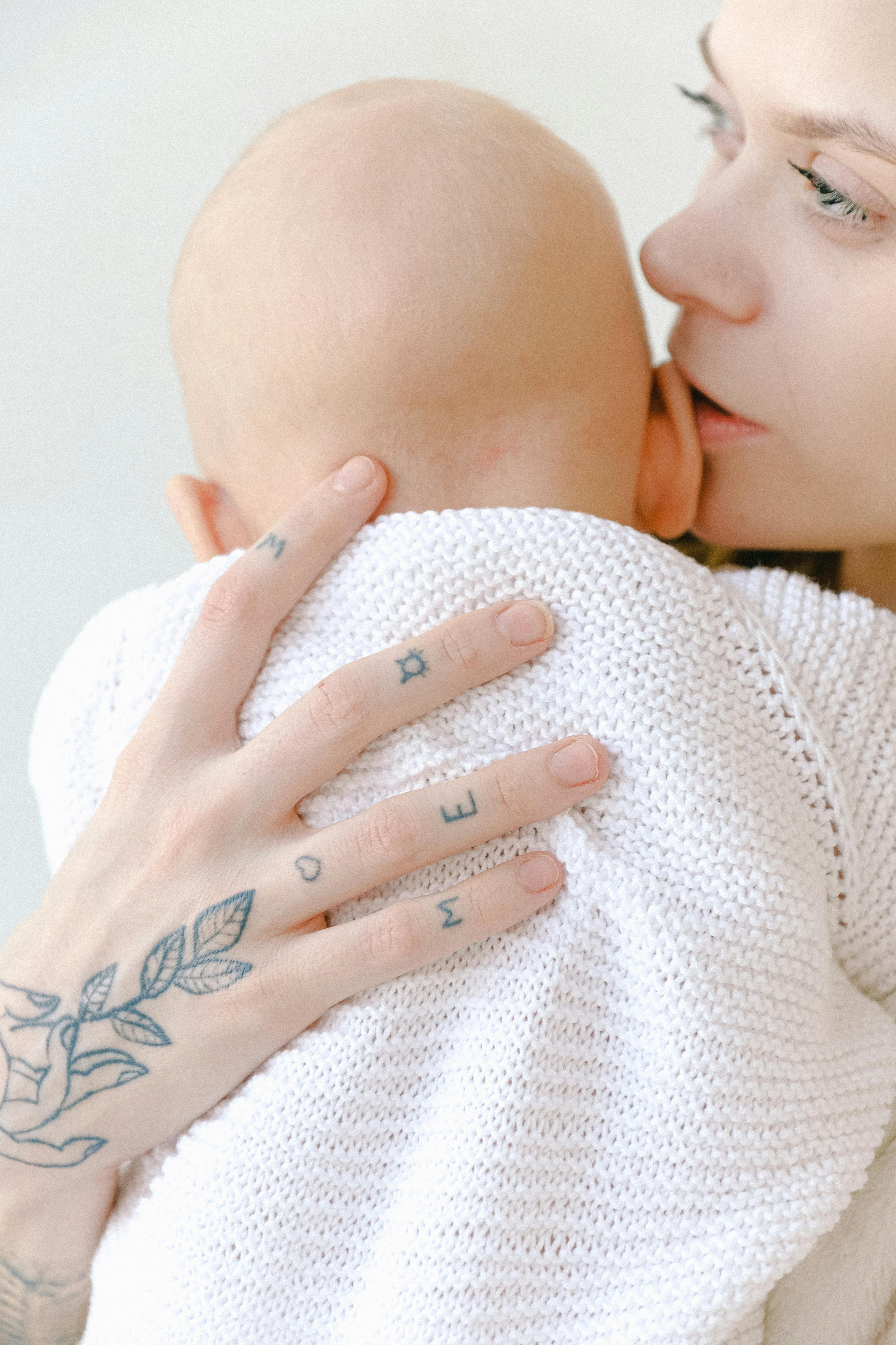 baby in white knit sweater