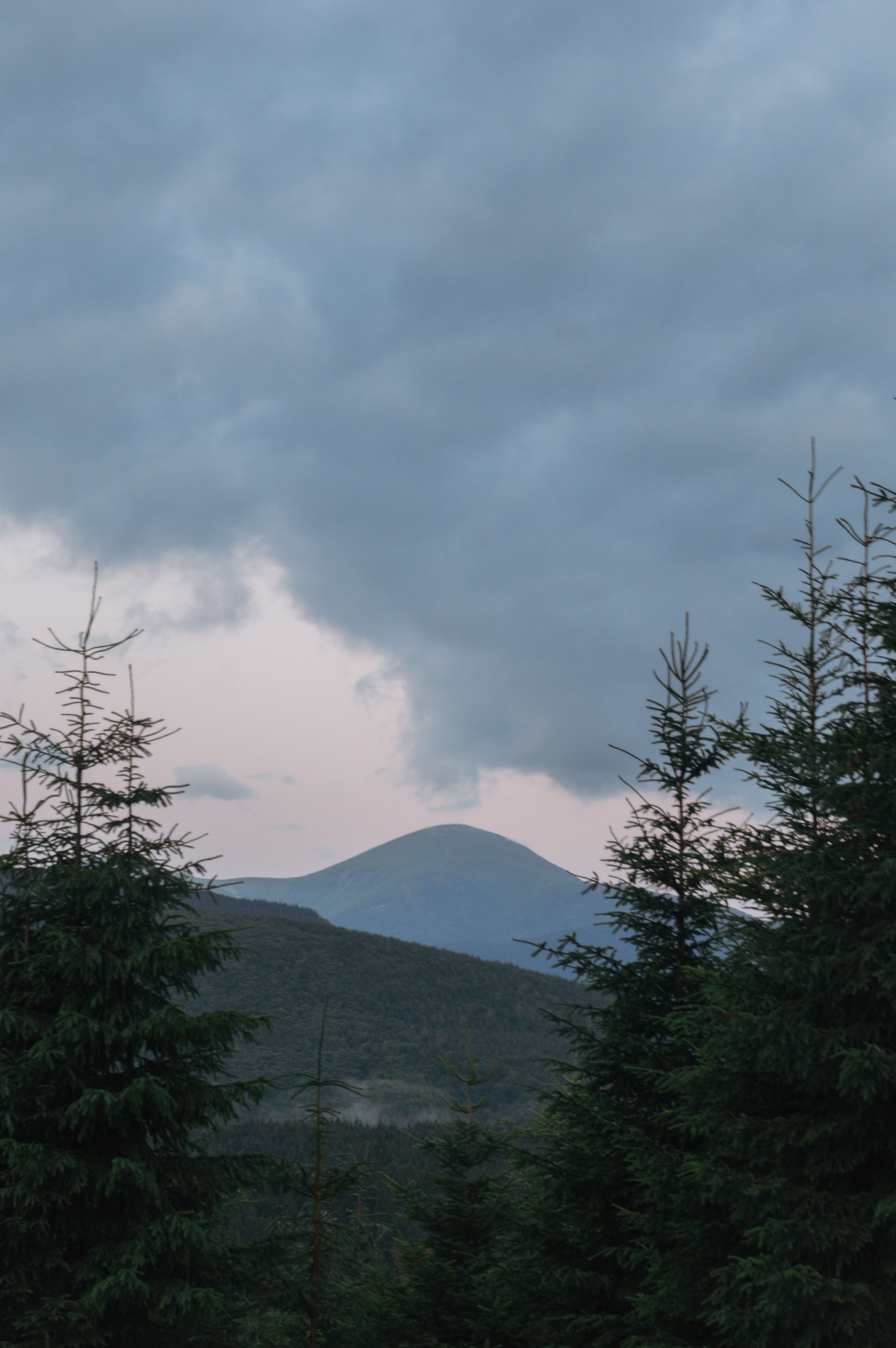 Tranquil view of a mountain landscape in Кривополье, Ukraine with a serene sky at dusk.