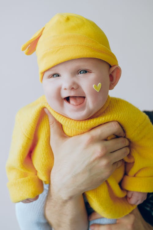 Free Baby in Yellow Knit Cap and Yellow Knit Sweater Stock Photo