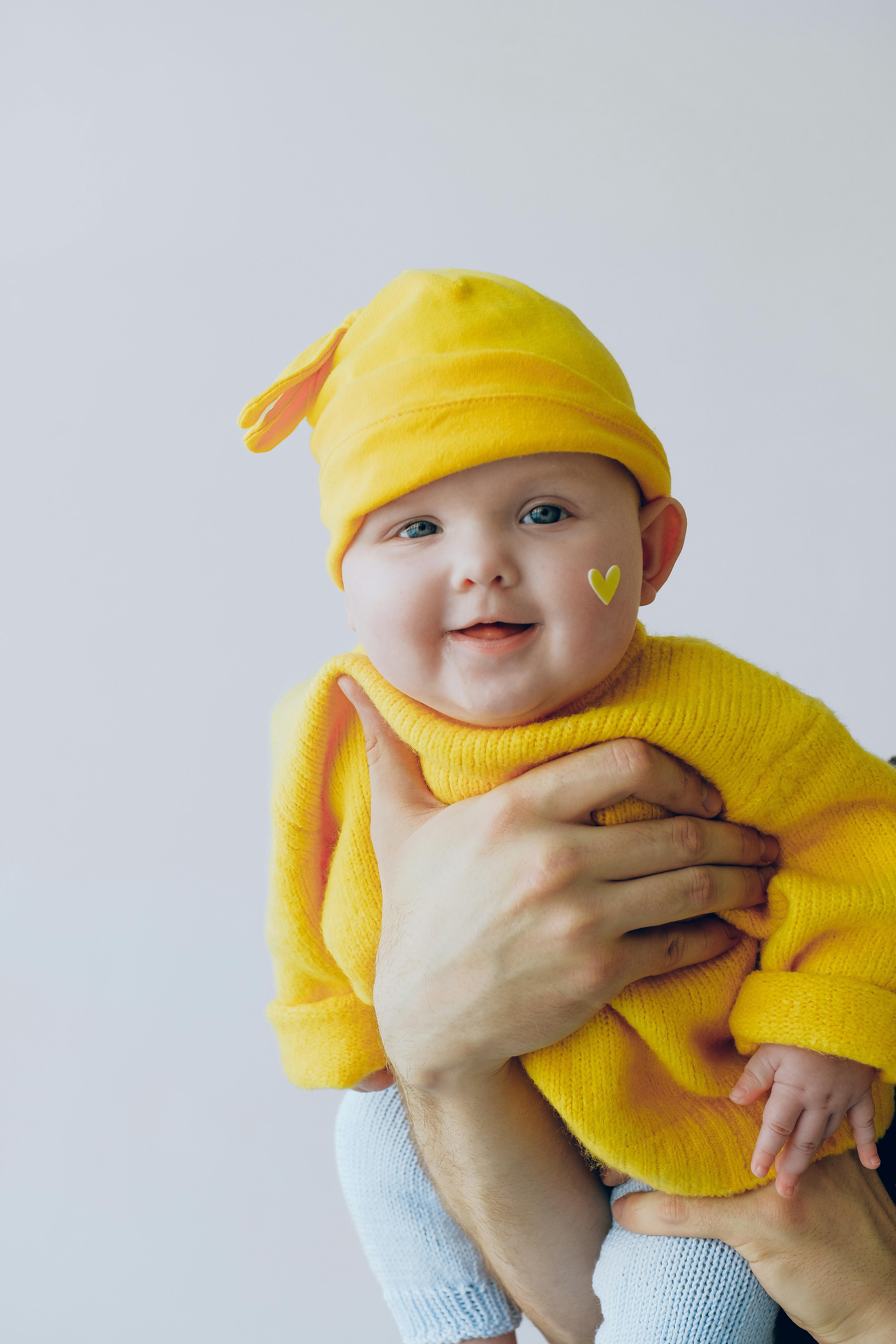baby in yellow knit sweater