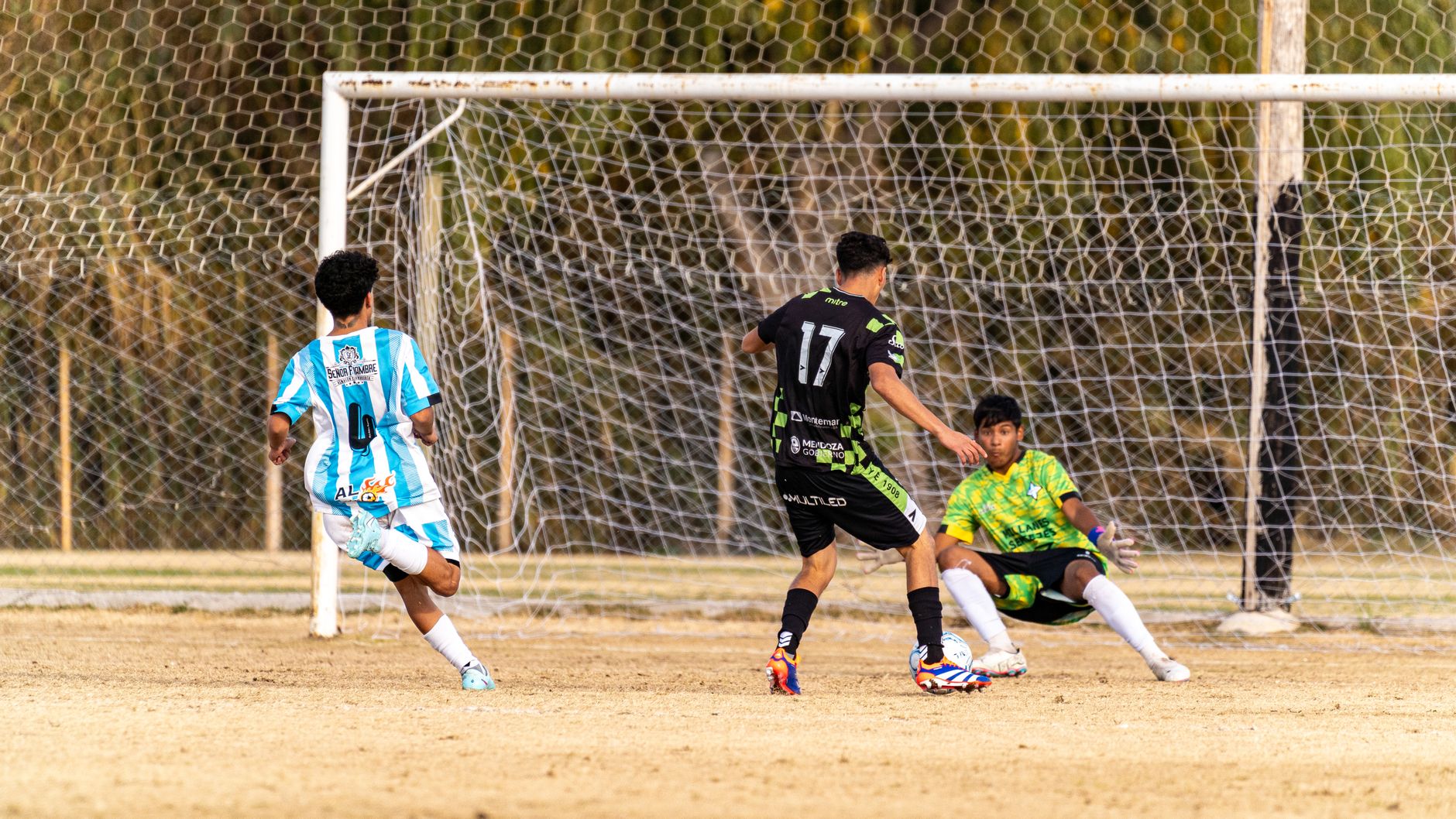 Action-packed moment during an outdoor soccer match with players in motion.