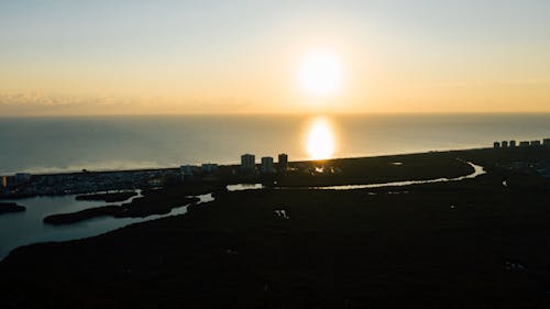 Free Amazing view of city on seashore at sunset Stock Photo