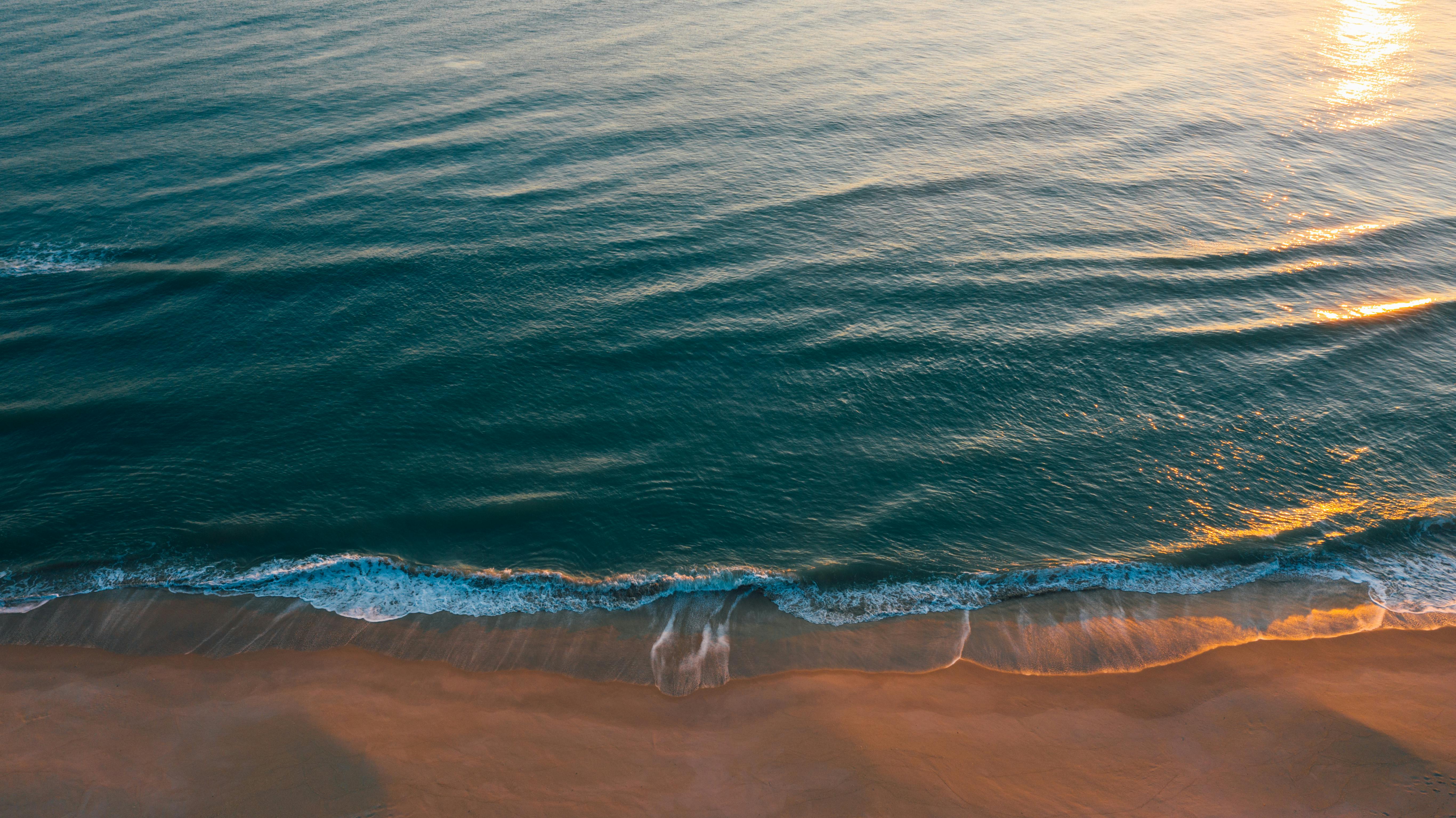 Soft Wave Of Blue Ocean On Sandy Beach