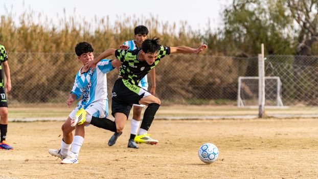 Dynamic action shot of a youth soccer match showcasing athleticism and competition.