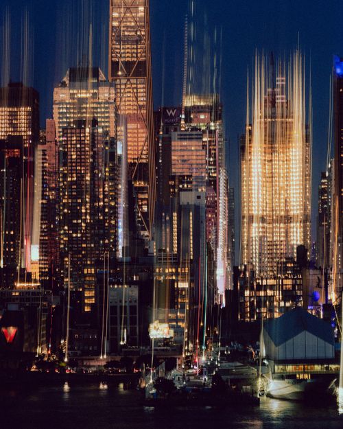 Free Artistic long-exposure cityscape of New York's skyline at night, showcasing vibrant architectural lights. Stock Photo
