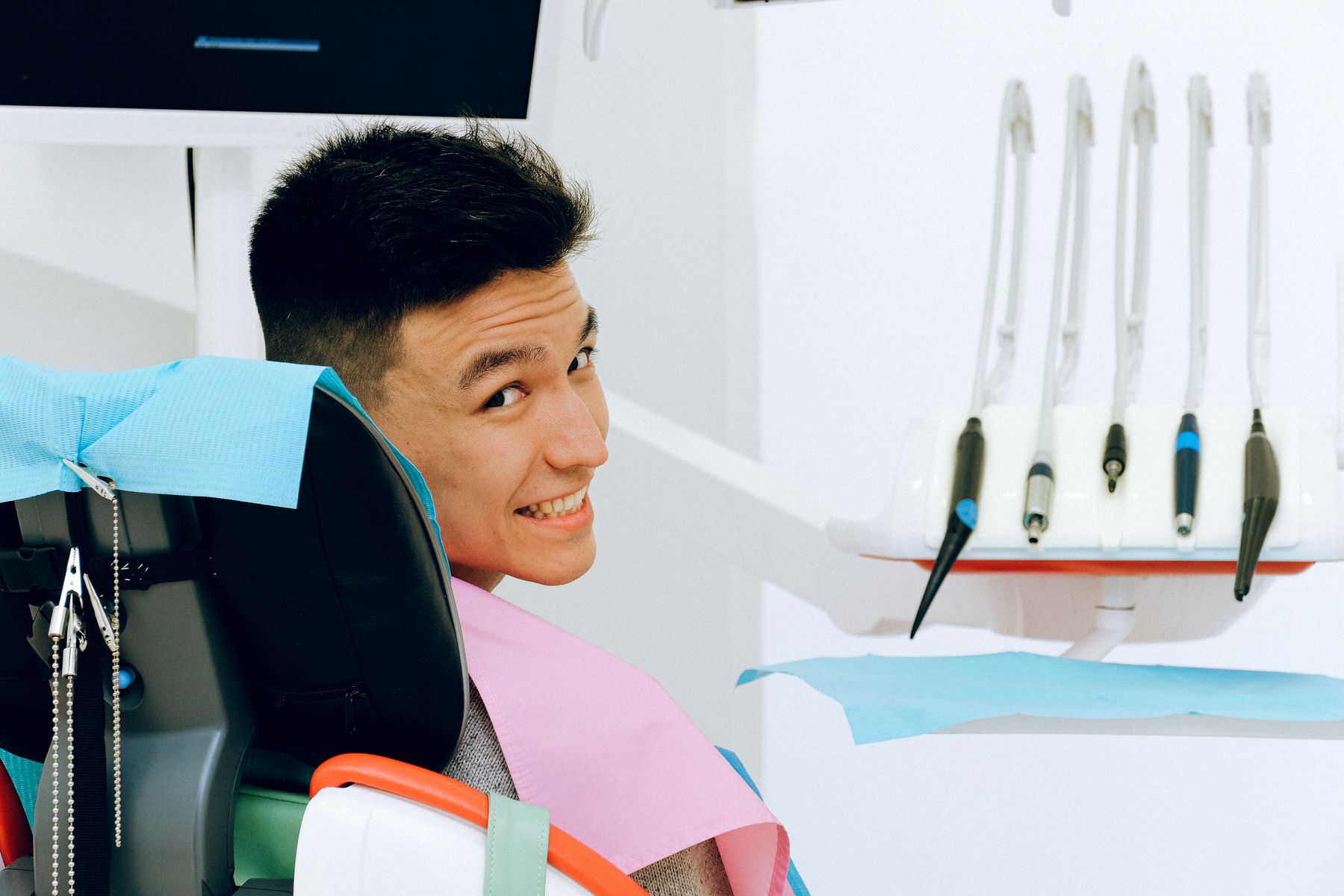 Smiling dental patient and clinician in a bright modern private dental clinic
