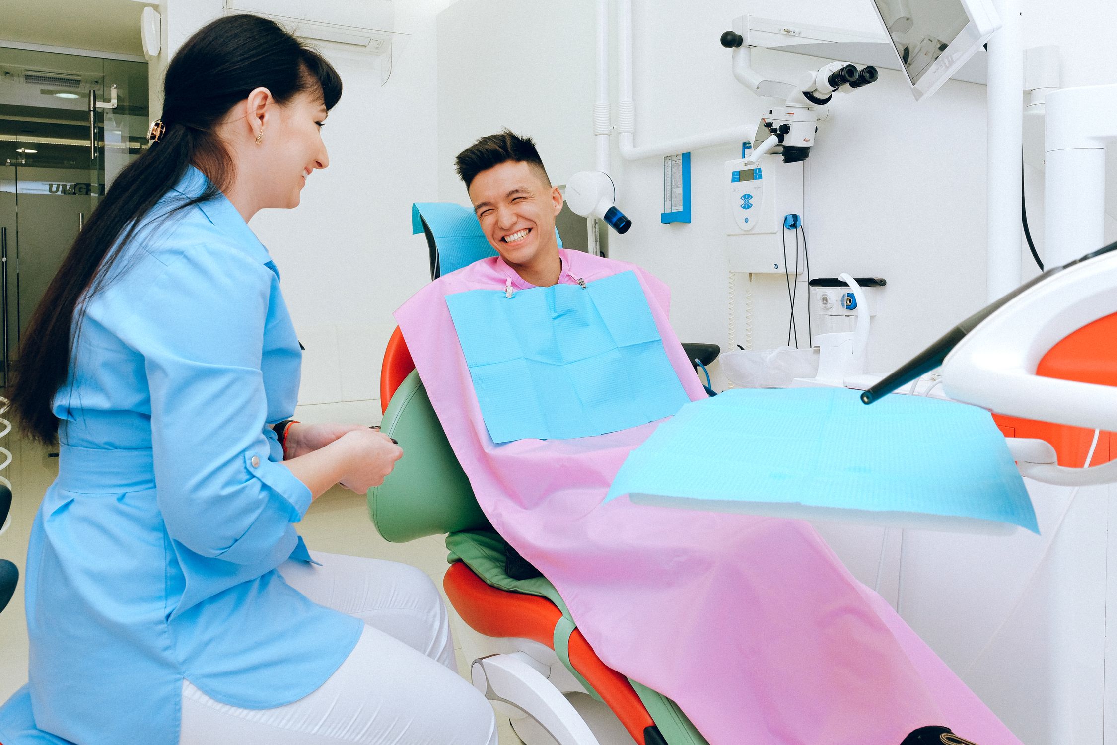 A cheerful patient sitting in a dental chair during a consultation at a modern dental clinic