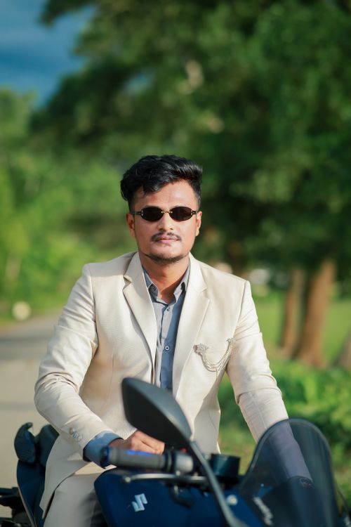 Free Confident man in sunglasses riding a motorcycle on a sunny day. Stock Photo