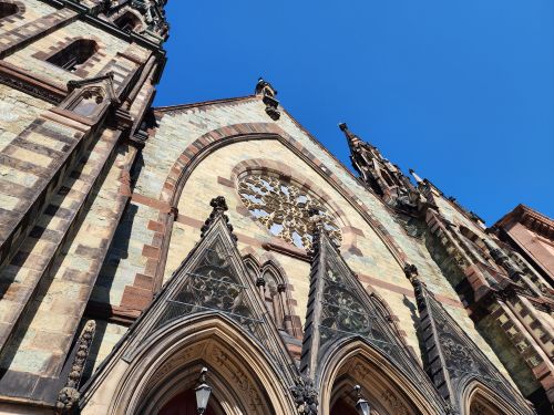 Free Stunning Gothic Revival church facade in Baltimore with vibrant blue sky backdrop. Stock Photo