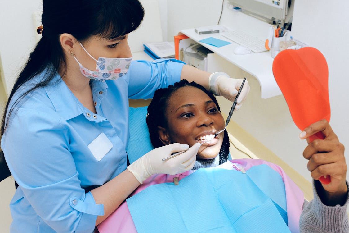 A photo showing a woman undergoing a dental examination.