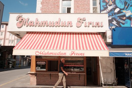 Captivating street view of Mahmudun Firini bakery with pedestrian passing by in Sakarya, Türkiye.