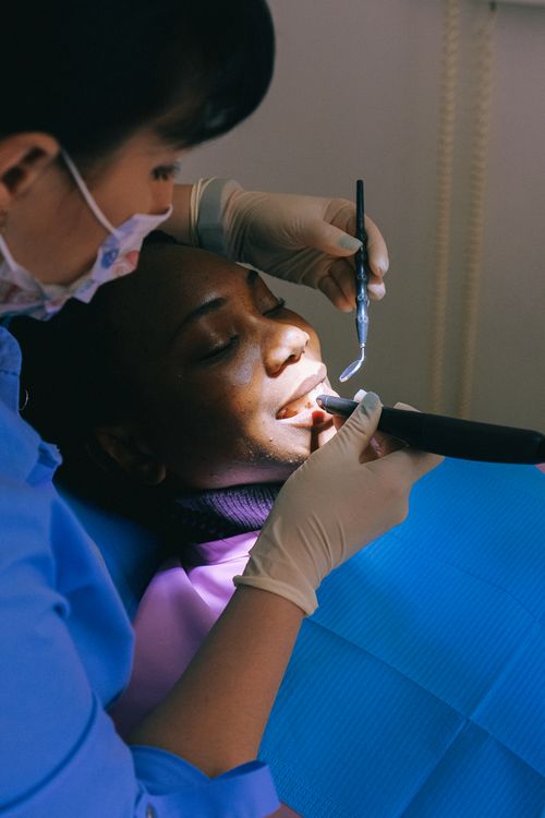 Free A dental professional examines a patient during a routine check-up in a clinic. Stock Photo