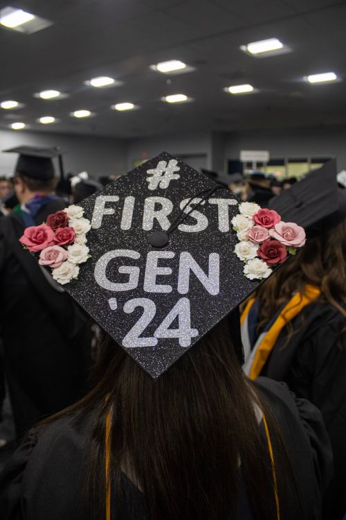 Free First-generation college graduate with decorated cap at a ceremony. Stock Photo
