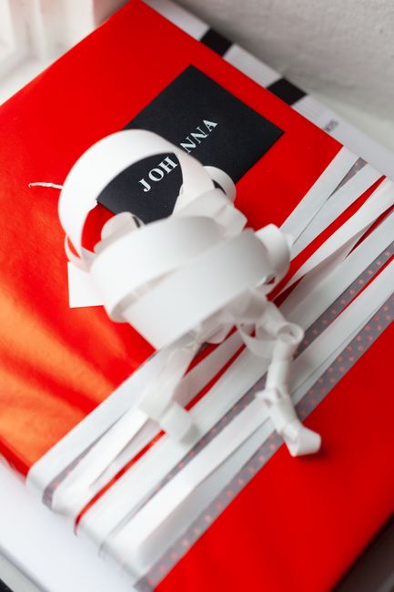 Hands wrapping a gift with care and attention to detail