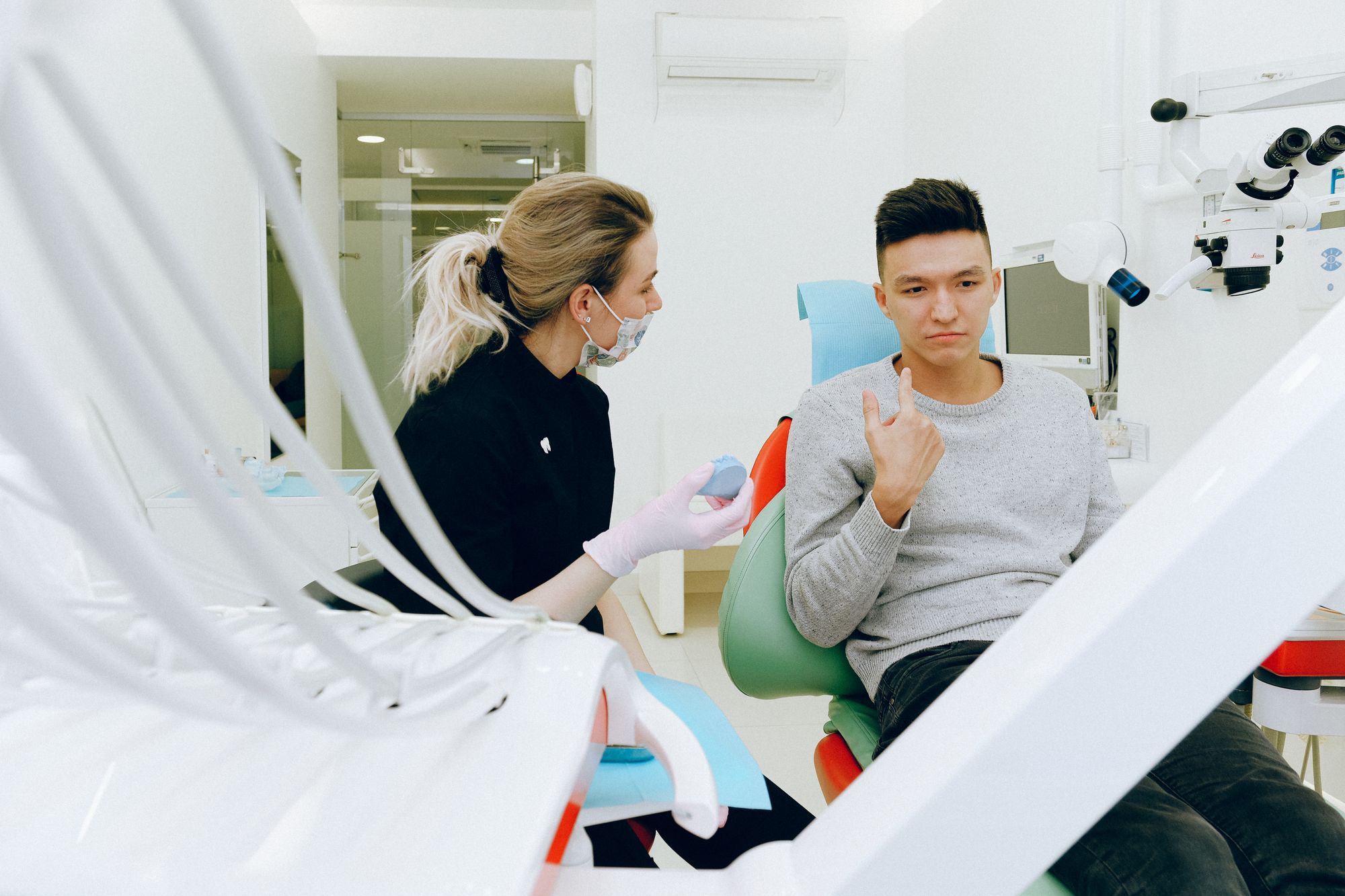 Dentist talking a patient through treatment