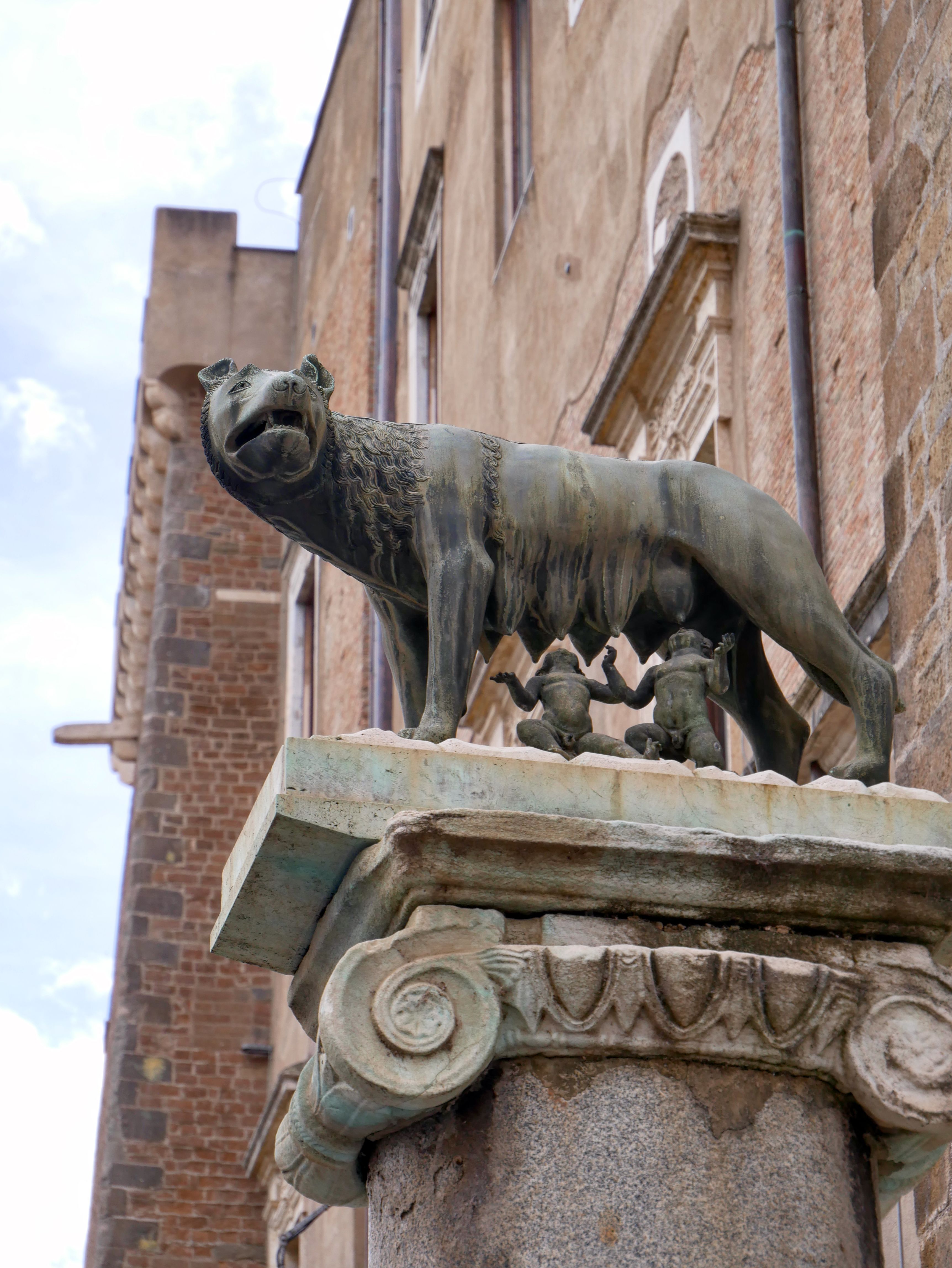 Bronze statue of Romulus and Remus with she-wolf, iconic Roman symbol.