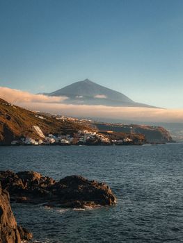 Breathtaking coastline view of Mount Teide in Tenerife, capturing its majestic presence against the sea.