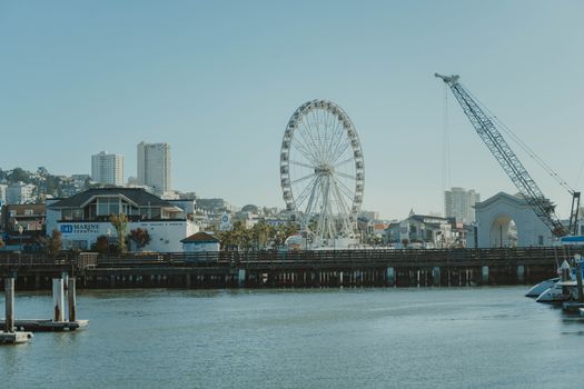 A beautiful waterfront view featuring a Ferris wheel in San Francisco, showcasing lively urban scenery.