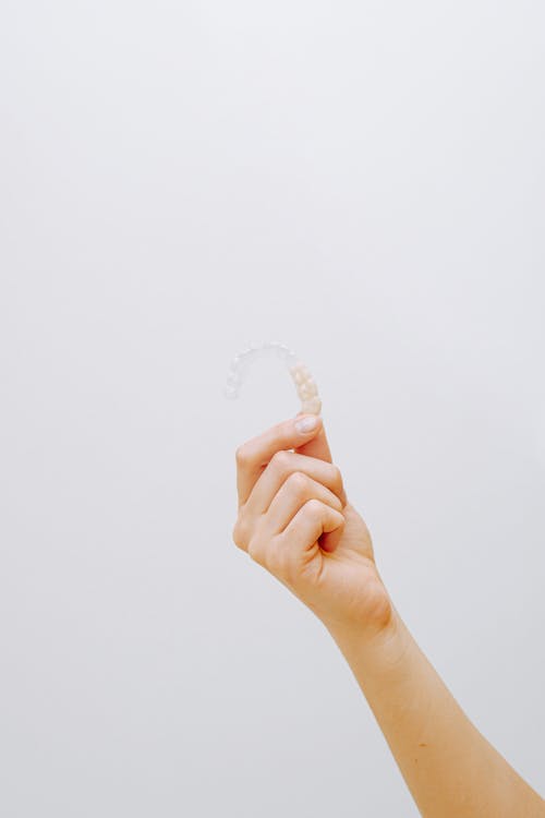Free Person Holding Clear Aligner Stock Photo