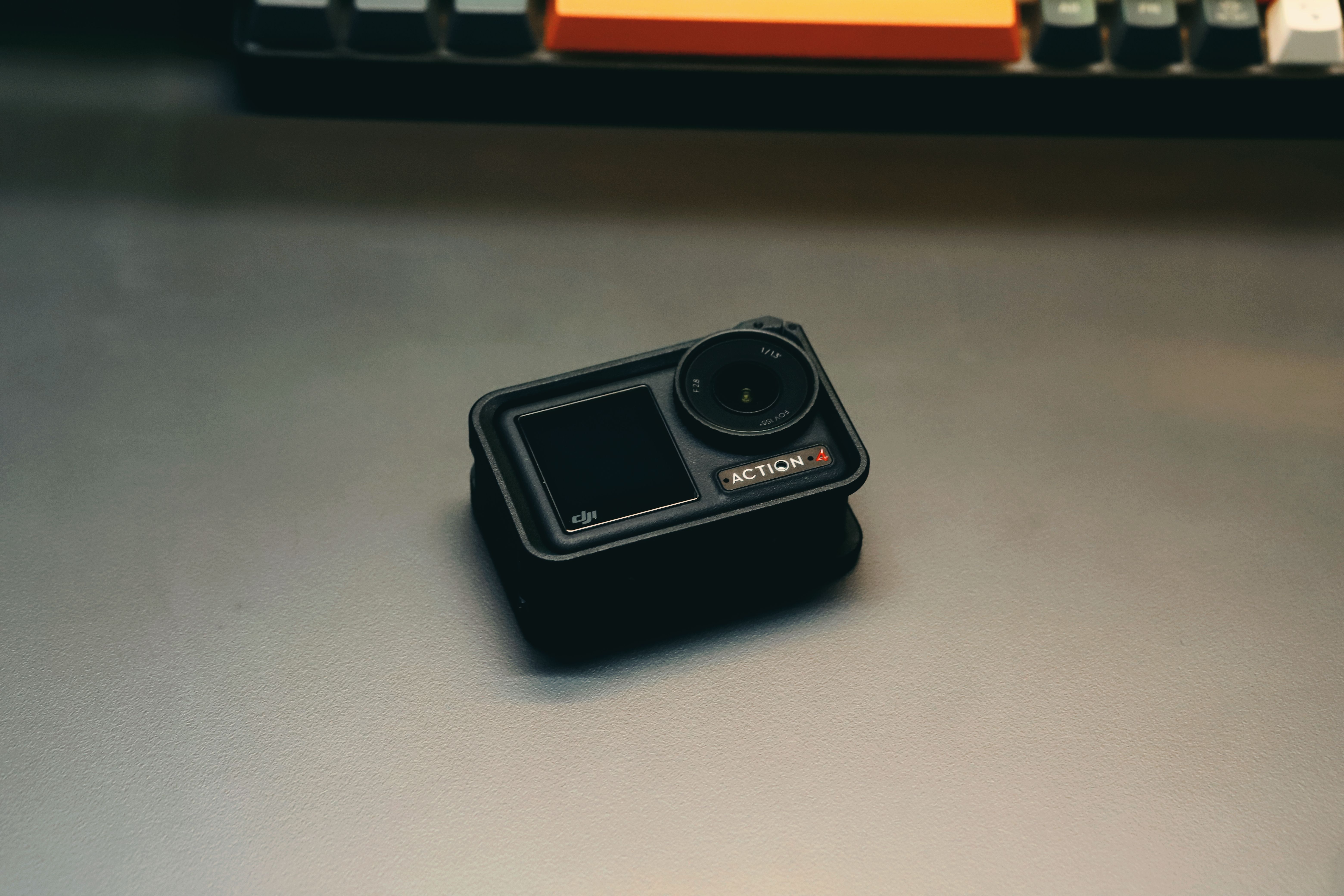 A high-quality image of a compact action camera resting on a desk, ideal for tech enthusiasts.