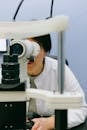 Unrecognizable female scientist watching through microscope