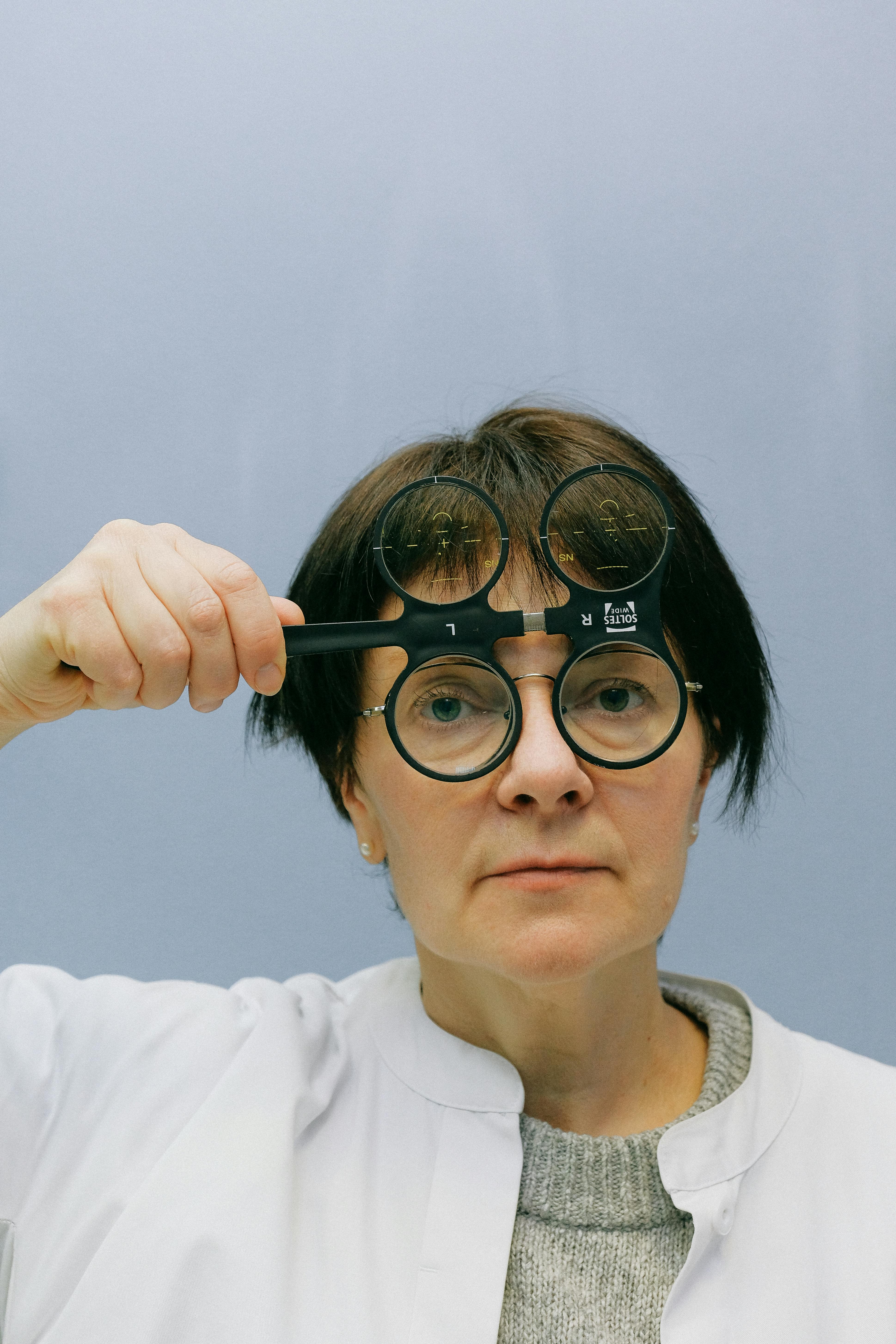 female doctor using ophthalmic magnifier with four lenses