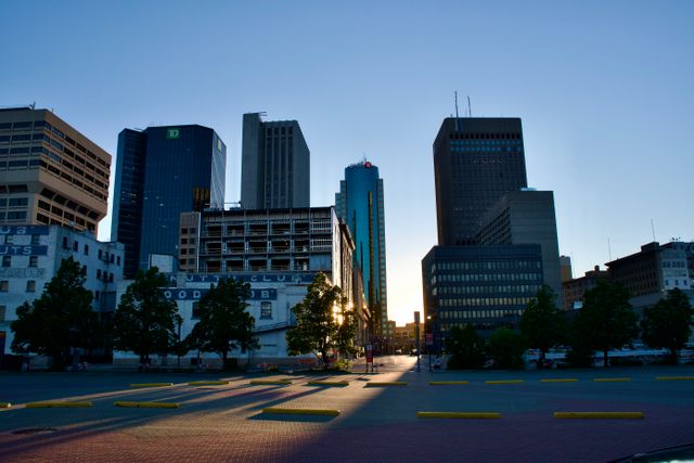 Stunning cityscape view of downtown Winnipeg, Manitoba, Canada during sunset with modern skyscrapers silhouetted.