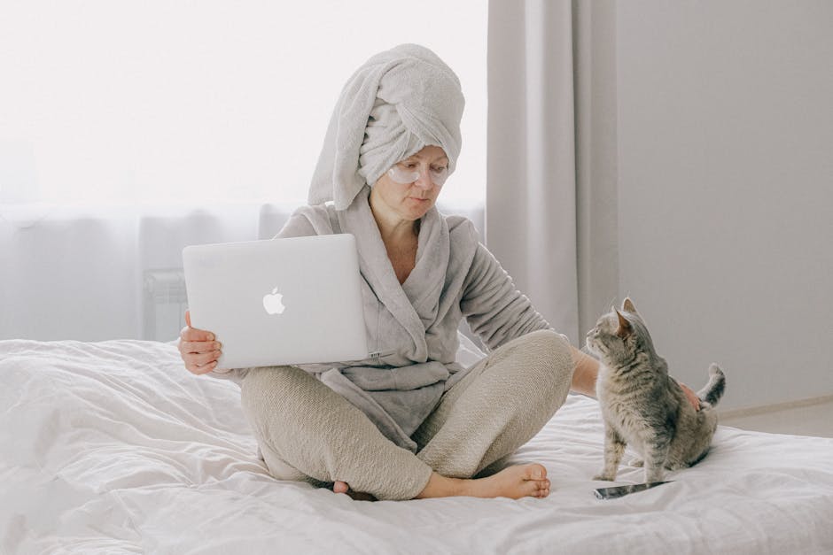 Woman in Gray Bathrobe Using Macbook