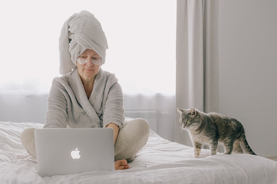 Woman Wearing A Robe Using A Laptop