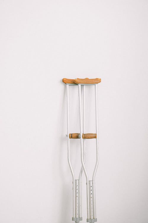 Crutches against light white wall