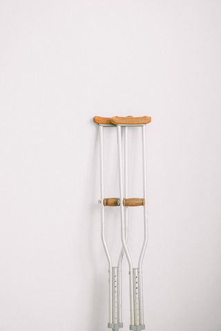 A pair of crutches against a white wall