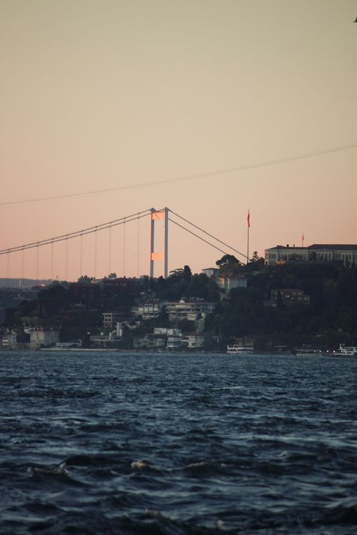 Free Scenic sunset view of Bosphorus Bridge spanning across the waters in Istanbul, Turkey. Stock Photo