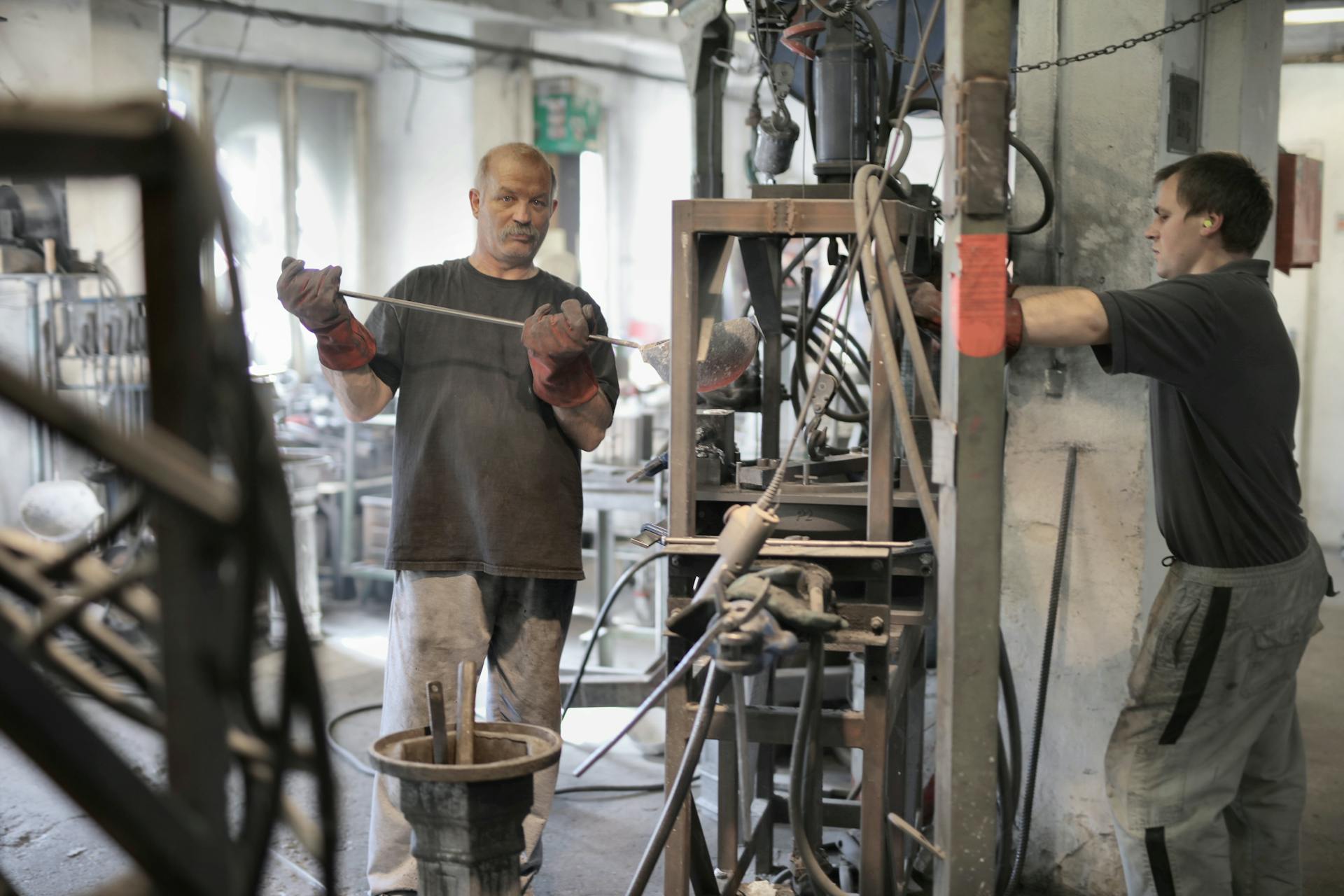 Skilled workers managing industrial equipment in a factory setting.