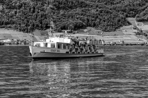 Free Black and white image of Stadt Biel ferry cruising on Lake Biel with vineyard backdrop. Stock Photo