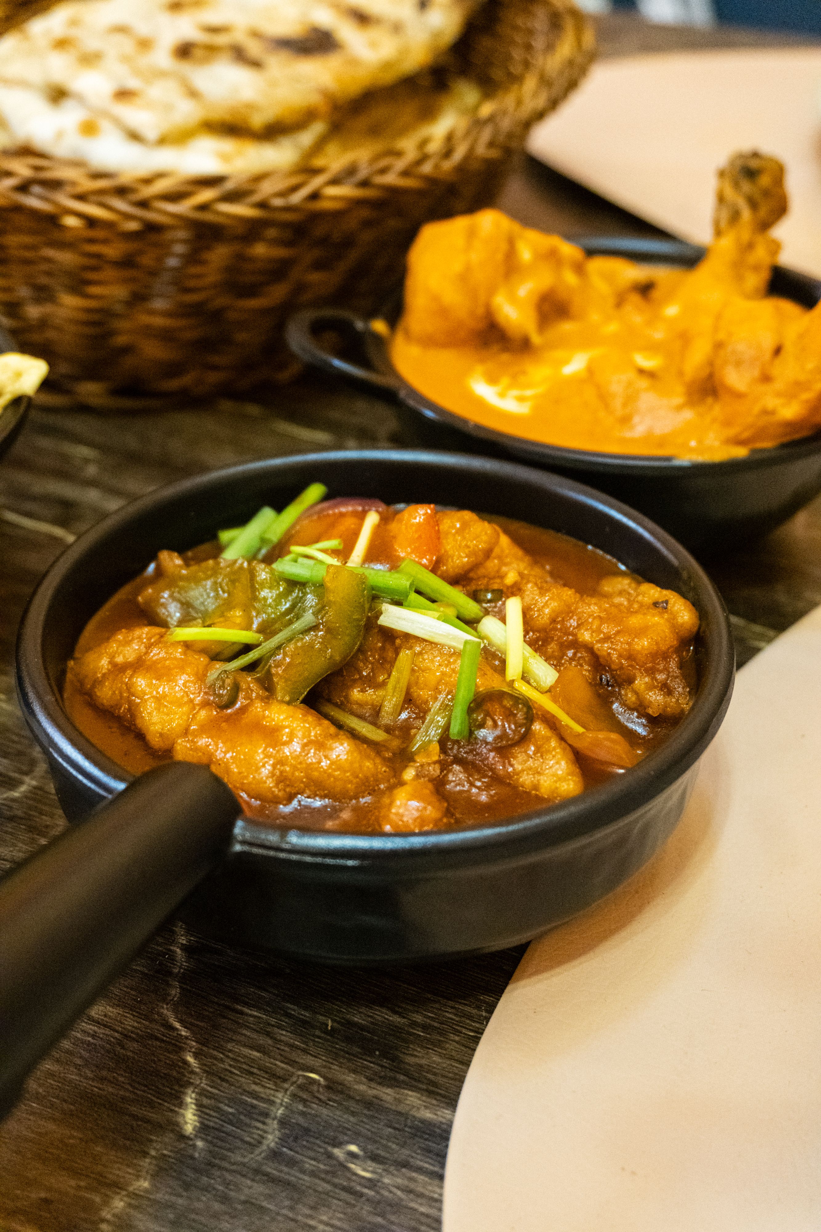 Tasty Indian curry served with naan and rice in a cozy setting.