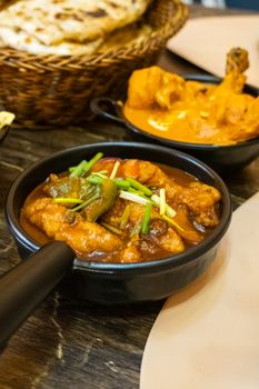 Tasty Indian curry served with naan and rice in a cozy setting.
