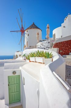 Stunning view of traditional white buildings and windmill in Santorini, Greece.
