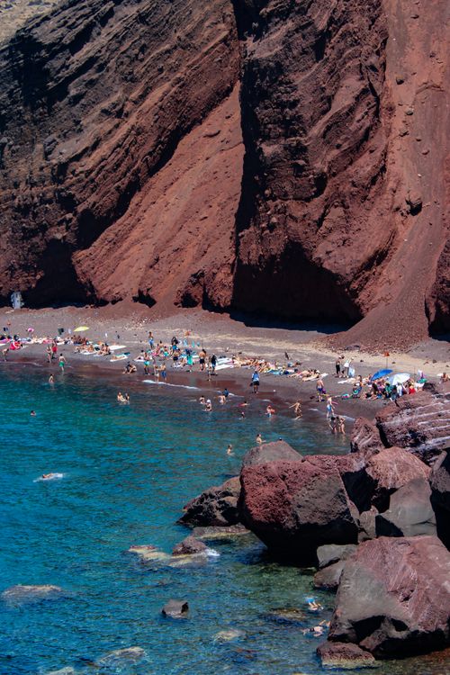Free Enjoy a sunny day at the stunning Red Beach in Santorini, Greece, with vibrant blue waters and red cliffs. Stock Photo