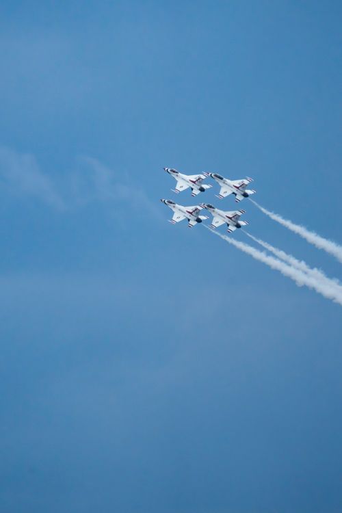 Free The USAF Thunderbirds flying in formation against a clear blue sky, showcasing precision aerobatics. Stock Photo