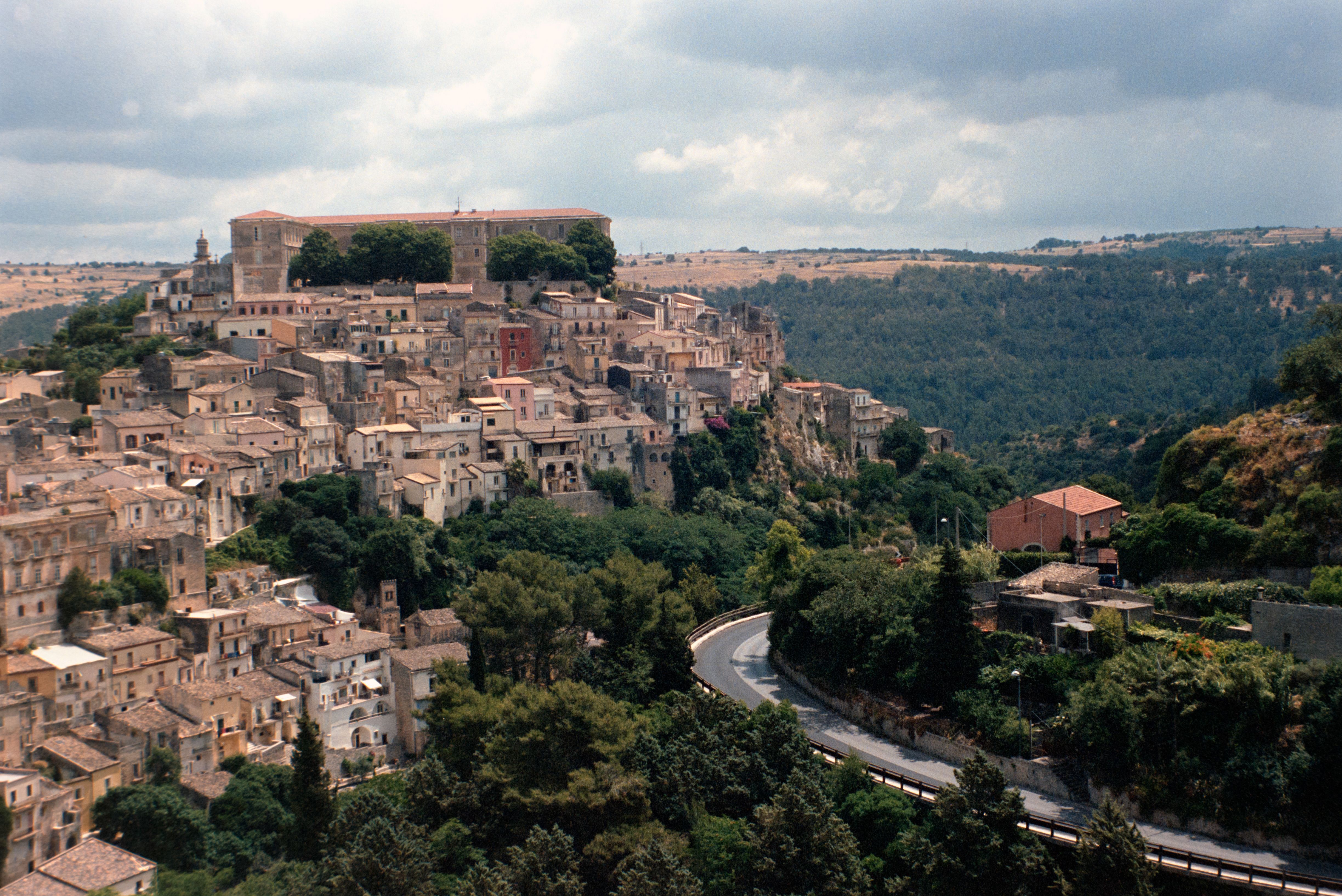 Picturesque aerial view of historic Ragusa Ibla, Sicily, surrounded by lush landscape.