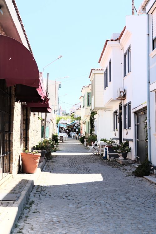 Free Beautiful cobblestone street lined with Mediterranean houses and colorful awnings. Stock Photo