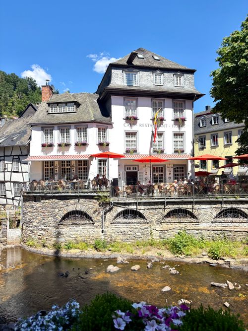 Free Quaint restaurant with outdoor seating in picturesque Monschau, Germany on a sunny day. Stock Photo