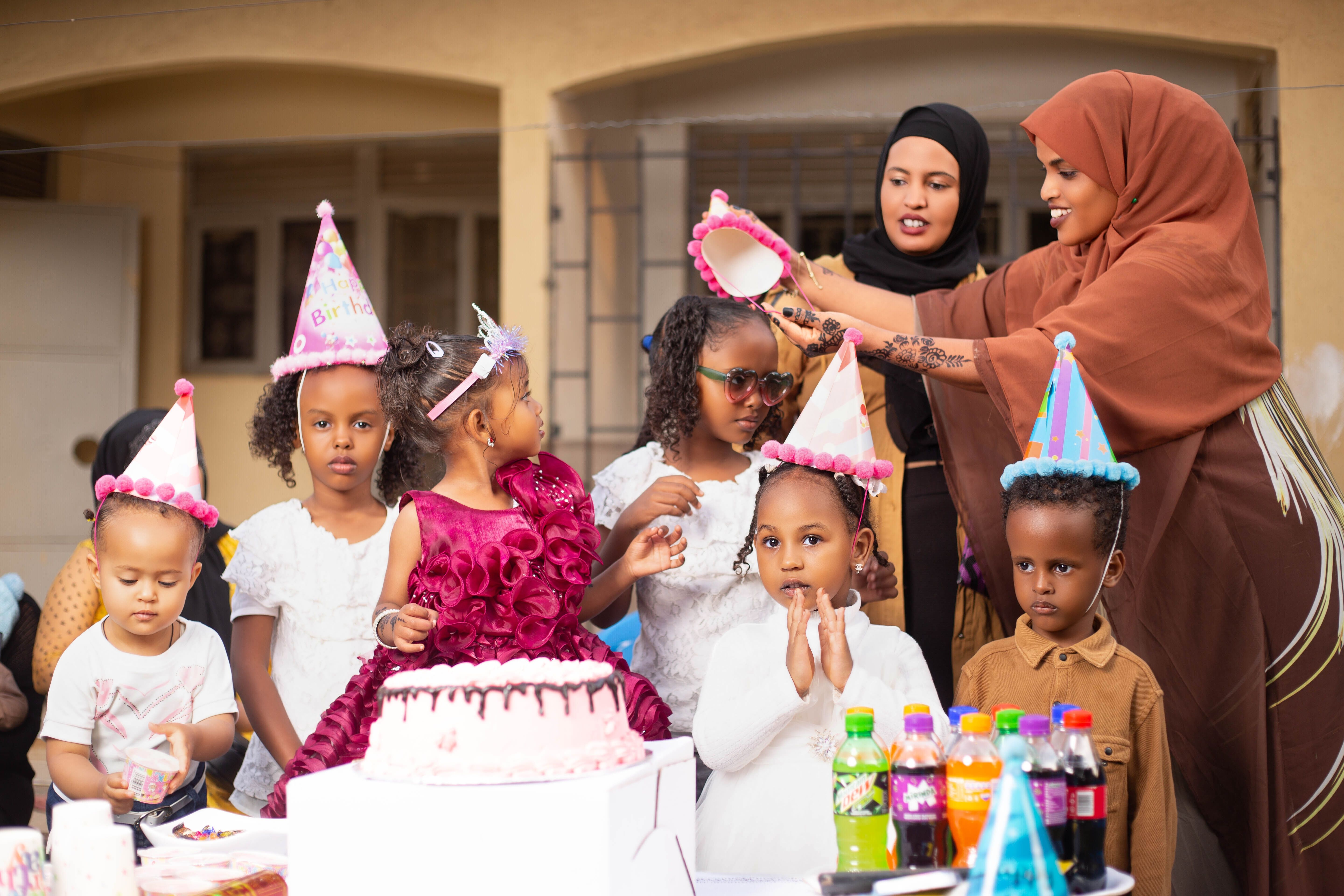 Happy children at a colorful outdoor birthday party enjoying cake and fun.