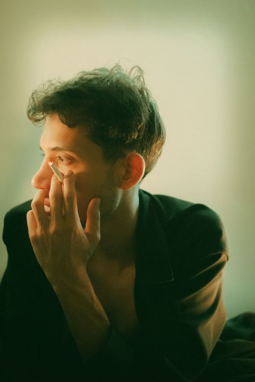 Free Side profile of a man deep in thought, illuminated by soft warm light indoors. Stock Photo