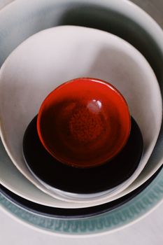 A collection of ceramic bowls stacked together showcasing vibrant colors and artistic design.