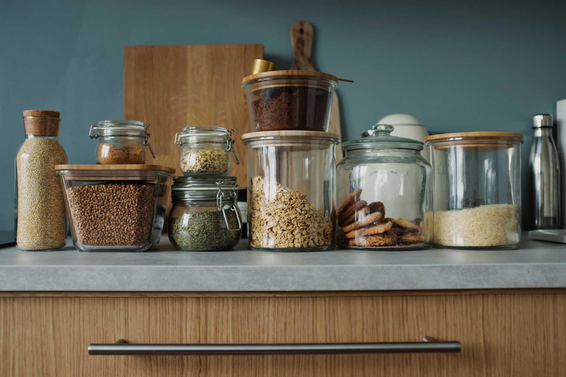 glass food storage containers filled with colorful meal prep ingredients on a kitchen counter